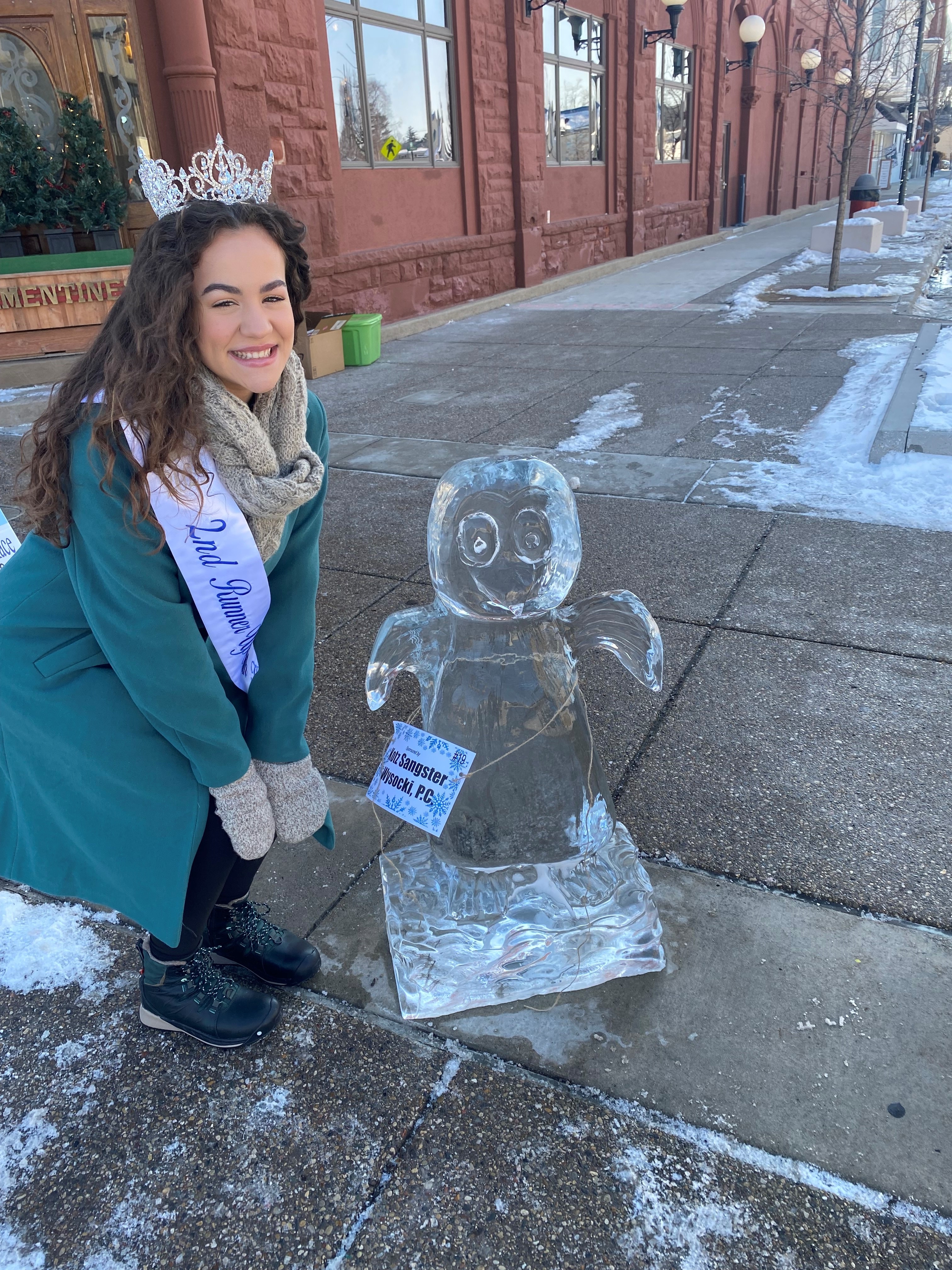 Miss South Haven pageant contestant Reese Garcia (daughter of KSW South Haven office employee) with the penguin ice sculpture Kotz Sangster sponsored.